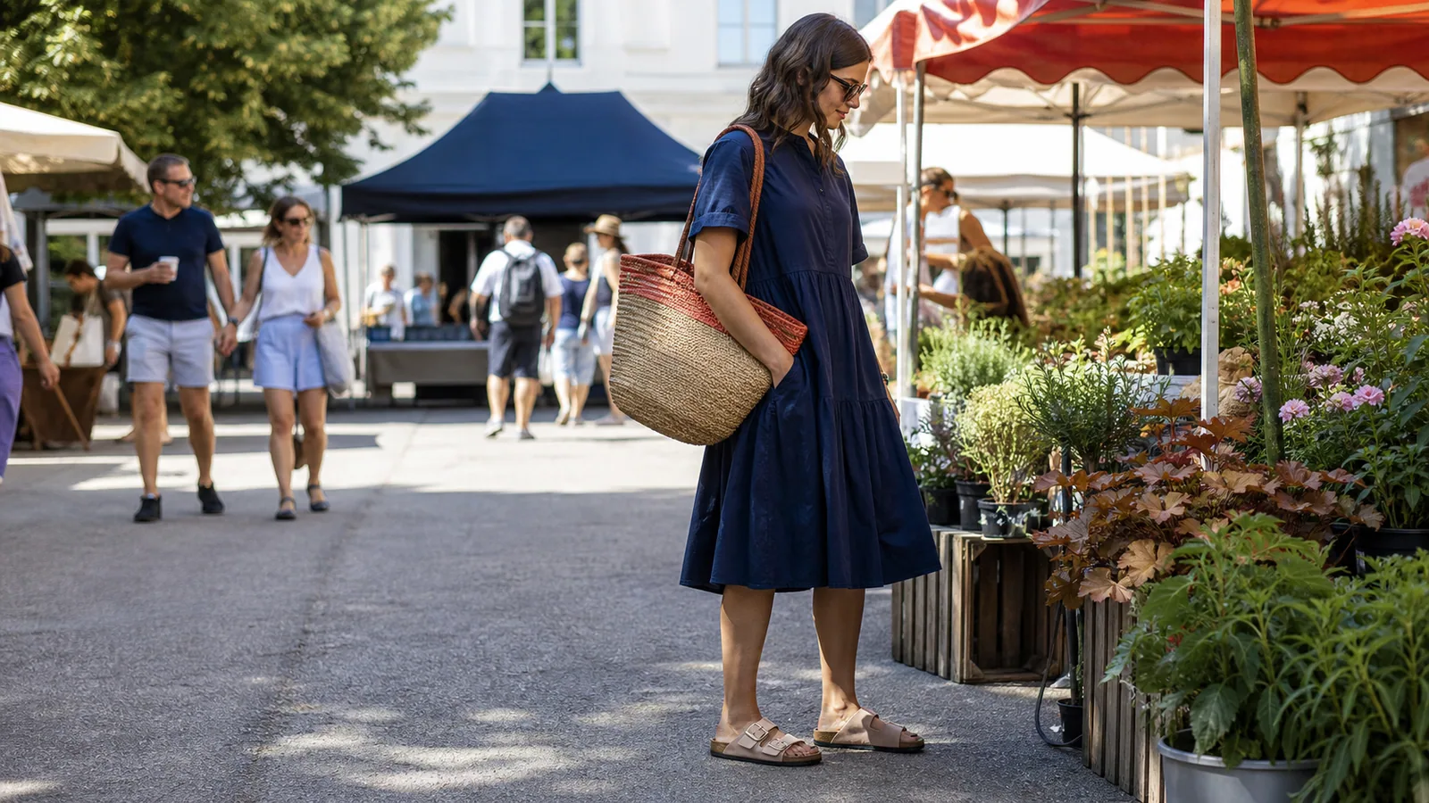 Person wearing two-strap footbed sandals at an outdoor weekend market